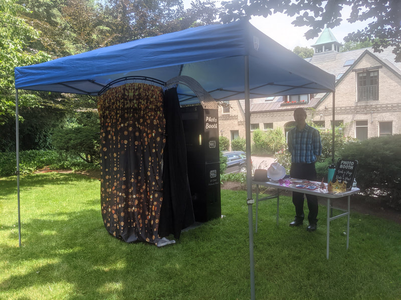 Photo booth outdoors at graduation party with canopy