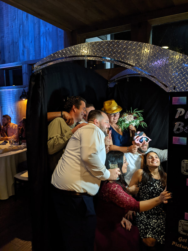 Wedding guests taking pictures in photo booth