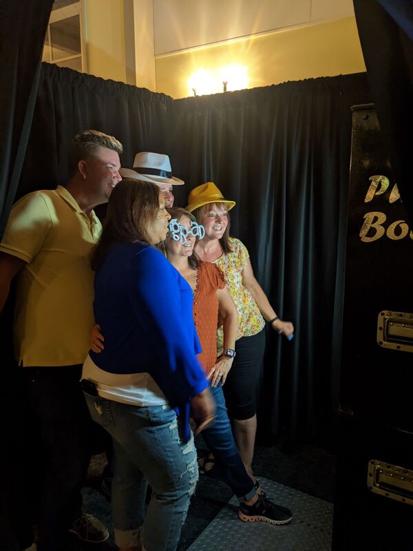 people posing in a vintage enclosed photo booth