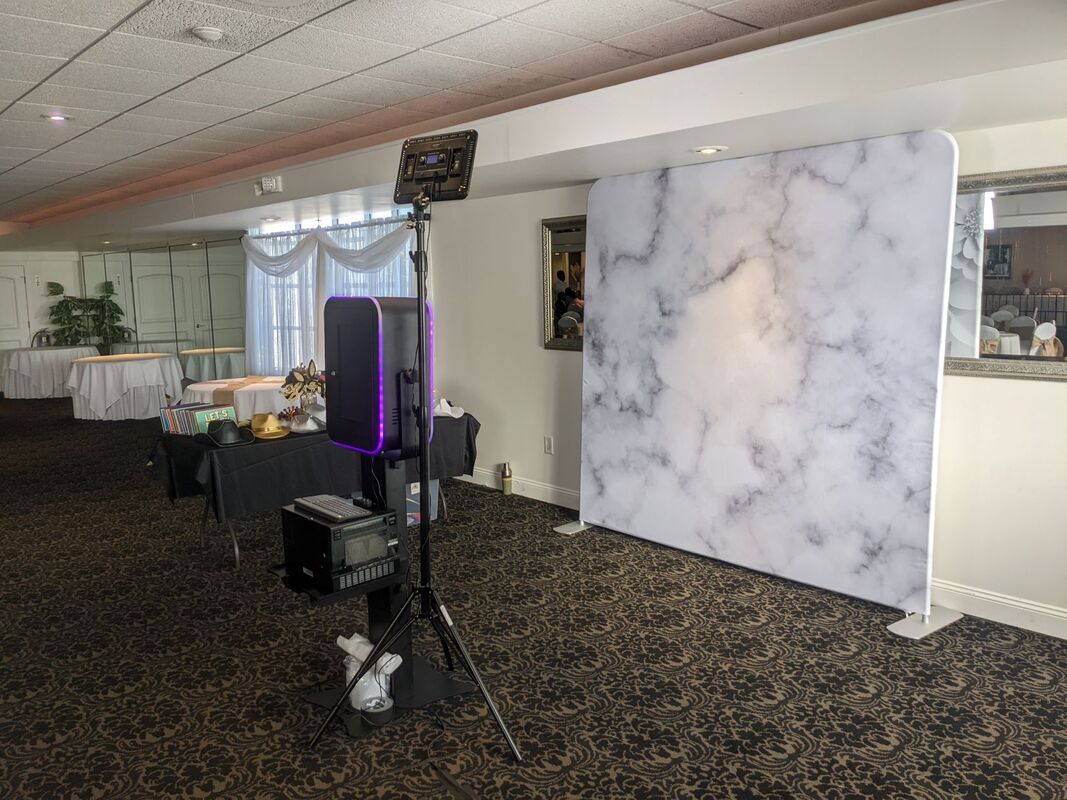 open air photo booth with marble backdrop